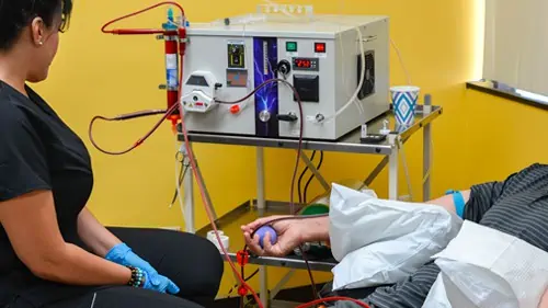 A patient being treated with the EBOO /F aphaeresis device.