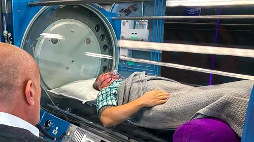 Dr. Milgrom observing a patient in one of our Sechrist H-Series Monoplace Hyperbaric Chambers.
