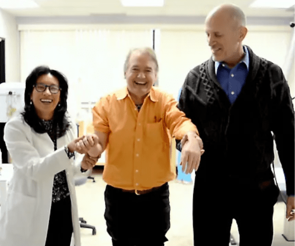 A joyful moment at AMA RegenMed as Dr. Pien supports a patient walking successfully, showcasing the life-changing results of stem cell therapy