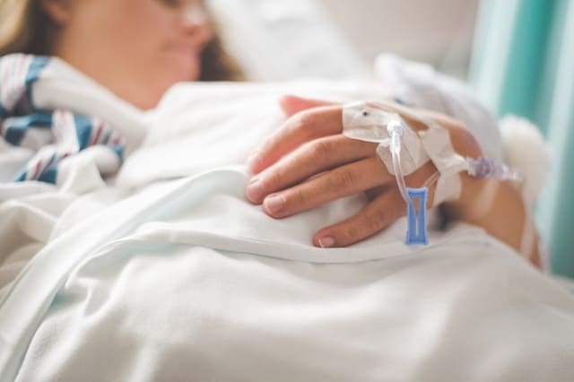 Close-up of a patient's hand with an IV line receiving a specialized NAD+ infusion for brain fog and mental clarity.