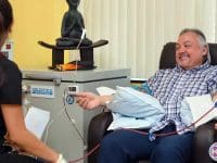 A happy male patient receiving EBOO (Extracorporeal Blood Ozonation) blood cleansing treatment in the clinic.