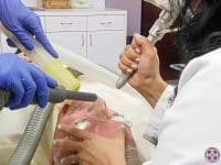 Patient receiving an Erbium laser treatment to remove or treat skin cancers and sun damage under professional care.