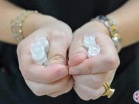 A close-up of multiple vials of quality-controlled stem cells held by a specialist, ready for clinical use.