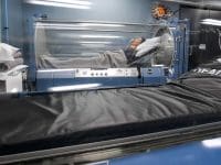 Patient inside a hyperbaric oxygen chamber (HBOT), a regenerative modality for chronic conditions like Long COVID.