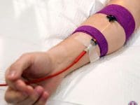 Patient receiving intravenous yellow light photobiomodulation therapy to help treat chronic Long COVID symptoms.