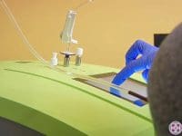 Close-up of a technician operating the touchscreen interface of the 10-Pass ozone therapy machine.