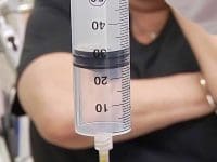 Detailed view of the needle tip during an ozone injection delivering therapeutic gas into the patient's shoulder joint.