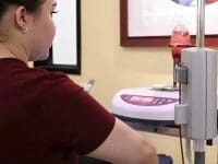 A nurse or technician setting up the ozone therapy device prior to starting the patient's treatment.