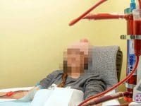 Post-Vaccine Syndrome patient connected to the EBOO ozone device for blood oxygenation therapy.