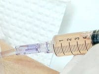 Concentrated stem cells or regenerative fluid being carefully infused via IV into a patient's arm during treatment.