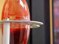 The glass container holding the patient's blood being infused with ozone during a 10-Pass Hyperbaric Ozone treatment.